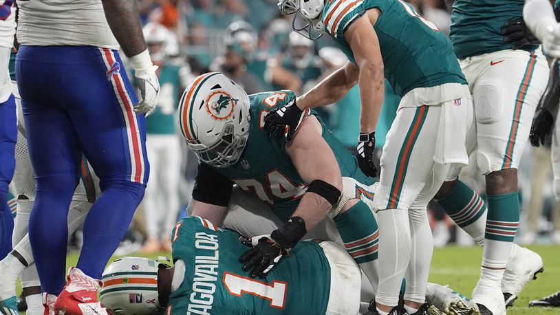 Miami Dolphins quarterback Tua Tagovailoa (1) lies on the field after suffering a concussion during the second half of an NFL football game against the Buffalo Bills, Thursday, Sept. 12, 2024, in Miami Gardens, Fla. (AP Photo/Lynne Sladky)