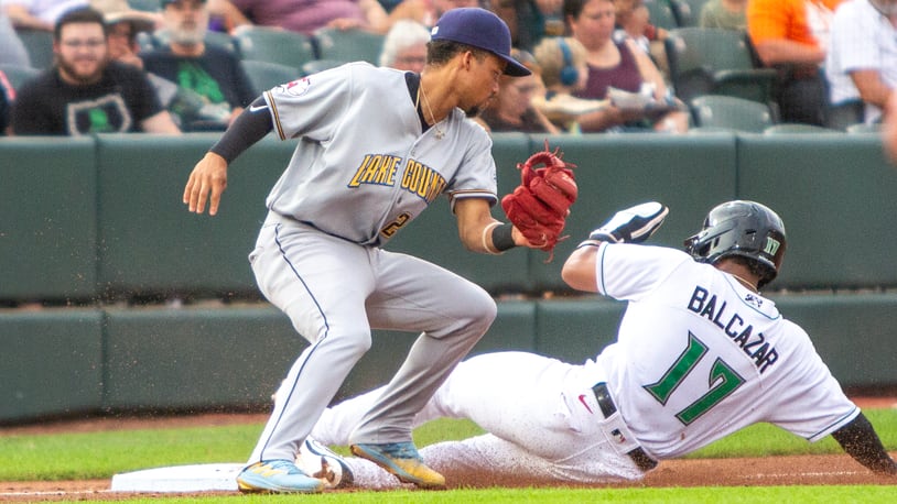 Dayton's Leo Balcazar slides safely into third base during Thursday night's game against Lake County at Day Air Ballpark. Jeff Gilbert/CONTRIBUTED