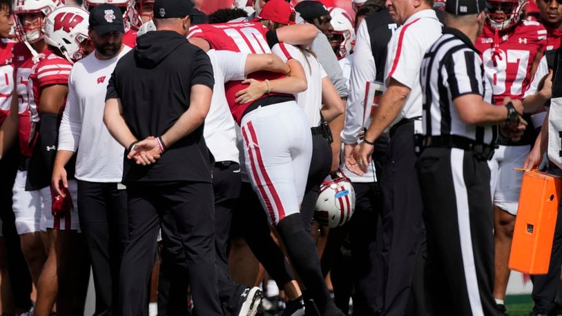 Wisconsin's Tyler Van Dyke (10) is helped off the field during the first half of an NCAA college football game against Alabama Saturday, Sept. 14, 2024, in Madison, Wis. (AP Photo/Morry Gash)