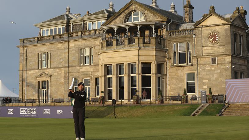 Lydia Ko, of New Zealand, holds up the trophy as Champion golfer in front of the Club house after winning the Women's British Open golf championship, in St. Andrews, Scotland, Sunday, Aug. 25, 2024. (AP Photo/Scott Heppell)