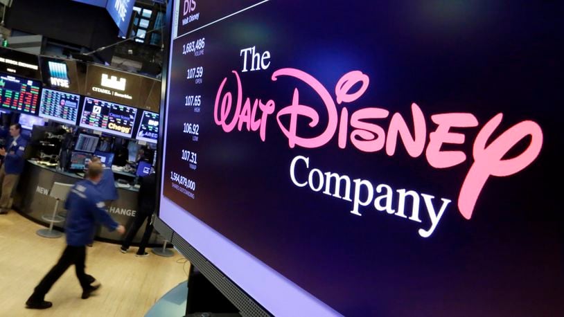 FILE - In this Aug. 8, 2017, file photo, The Walt Disney Co. logo appears on a screen above the floor of the New York Stock Exchange. (AP Photo/Richard Drew, File)