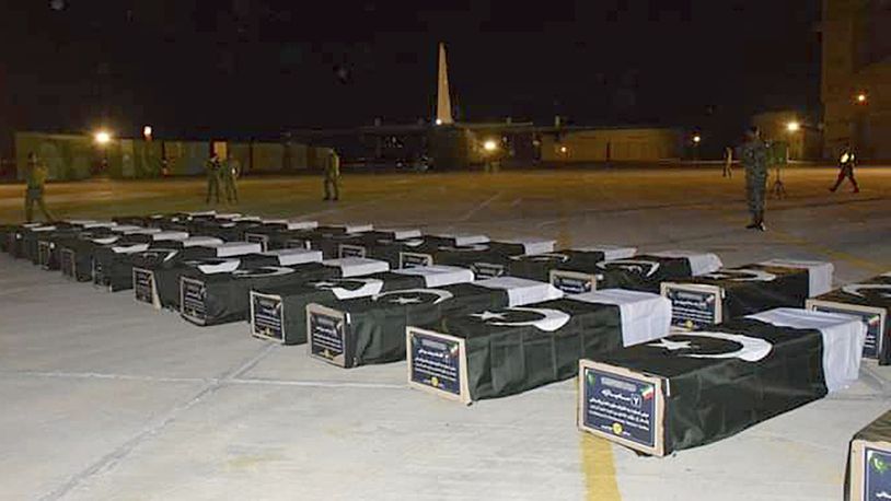 In this photo released by the Pakistan Air Force, bodies of Shiite Muslim pilgrims who were killed in a bus crash in Iran while heading to Iraq for a pilgrimage, arrive at an airbase in Jacobabad, Pakistan, Saturday, Aug. 24, 2024. (Pakistan Air Force via AP)