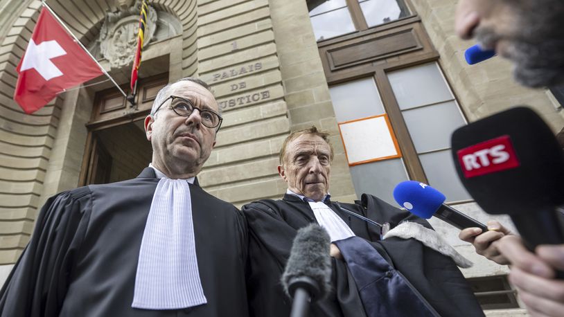 Lawyers of the accused, Nicolas Jeandin, left, and Robert Assael, right, leave the court house after a break in the reading of the verdict, during the trial against members of the billionaire Hinduja family, in Geneva, Switzerland, Friday June 21, 2024. A Swiss criminal court on Friday sentenced four members of the billionaire Hinduja family with between four and 4 1/2 years in prison for exploiting their vulnerable domestic workers while at the same time dismissing the more severe charges of human trafficking. (Martial Trezzini/Keystone via AP)