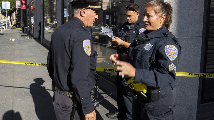 San Francisco Police Department Sgt. Joelle Harrell, right, at the scene of a shooting in Union Square, where San Francisco 49ers rookie wide receiver Ricky Pearsall was shot in the chest during an attempted robbery, Saturday, Aug. 31, 2024, in San Francisco. (Santiago Mejia/San Francisco Chronicle via AP)