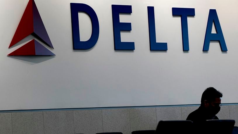 FILE - A man waits for a Delta Airlines flight at Hartsfield-Jackson International Airport in Atlanta, Jan. 7, 2022. (AP Photo/Charlie Riedel, File)