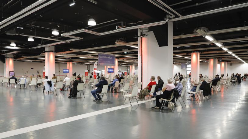 FILE - People rest after receiving the vaccination against the new coronavirus in the 'Austria Center Vienna' in Vienna, Austria, Friday, April 9, 2021. (AP Photo/Lisa Leutner, File)