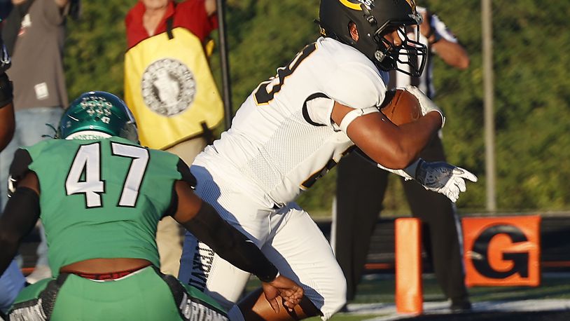 Centerville's Parker Johnson carries the ball into the end zone against Northmont last season. BILL LACKEY/STAFF