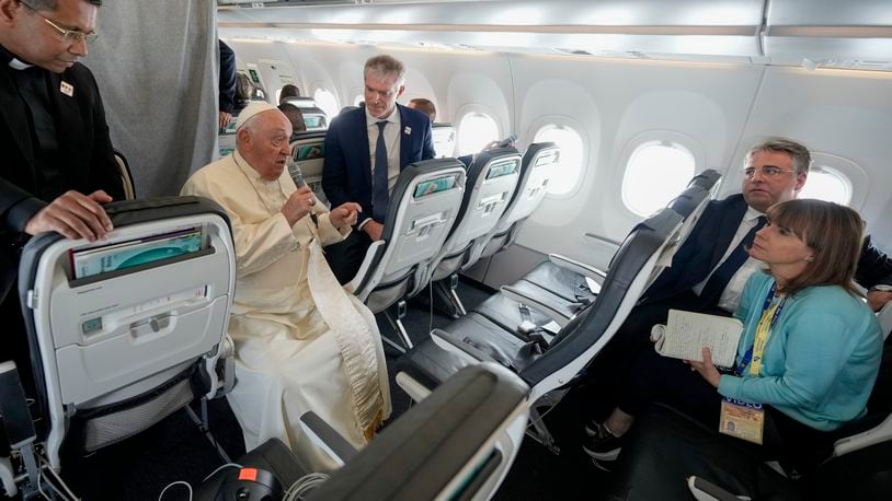 Pope Francis talks to journalists on the flight back to Rome at the end of his four-day visit to Belgium and Luxembourg, Sunday, Sept. 29, 2024. (AP Photo/Andrew Medichini, Pool)