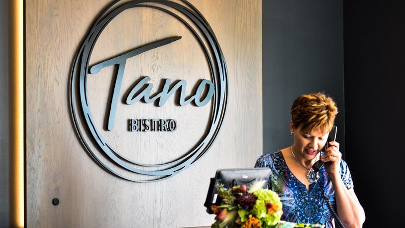 Tano Bistro is located at 150 Riverfront Plaza in the first floor of The Marcum, a mixed-used development in Hamilton. Tyler McCleary, director of operations, says it's “always a struggle” regarding mask wearing because his business is concerned about the safety and well being of its staff and guests. NICK GRAHAM/STAFF