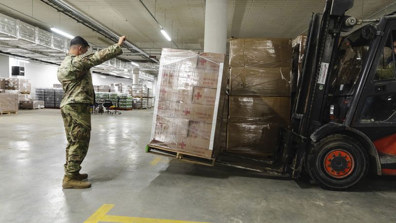 FILE - In this image provided by the U.S. Army, paratroopers assigned to the 82nd Airborne Division, assist with unloading humanitarian goods in support of the United States Agency for International Development (USAID) in preparation of potential evacuees from Ukraine at the G2A Arena in Jasionka, Poland, on Feb. 25, 2022. Charitable giving dropped 2.1% in 2023 after inflation, according to the most recent Giving USA report, the key findings of which were released Tuesday, June 25, 2024. (Sgt. Robert Whitlow/U.S. Army via AP, File)