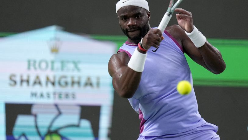 Frances Tiafoe of the United States returns a shot to Zhou Yi of China during the men's singles second round match in the Shanghai Masters tennis tournament at Qizhong Forest Sports City Tennis Center in Shanghai, China, Monday, Oct. 7, 2024. (AP Photo/Andy Wong)