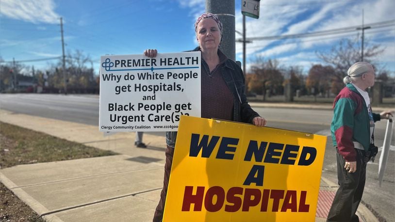 Nancy Kiehl, a member of the Clergy Coalition Community, protests outside of a ceremonial groundbreaking event on Friday, Oct. 28, 2022, for a new facility on the former Good Samaritan Hospital site. CORNELIUS FROLIK / STAFF