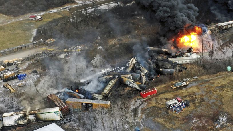 FILE - Debris from a Norfolk Southern freight train lies scattered and burning along the tracks on Feb. 4, 2023, the day after it derailed in East Palestine, Ohio. A federal judge has signed off Tuesday, May 21, 2024, on the $600 million class action settlement over last year's disastrous Norfolk Southern derailment in eastern Ohio, but many people who live near East Palestine are still wondering how much they will end up with out of the deal. (AP Photo/Gene J. Puskar, File)
