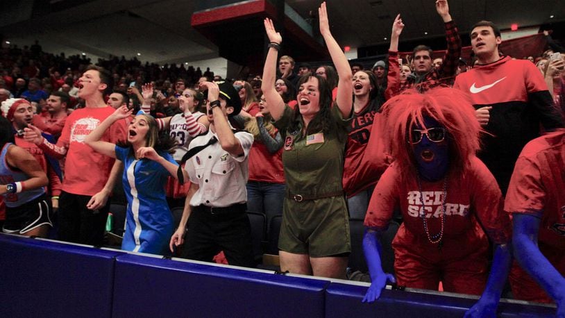 Fans in the Red Scare student section cheer during a game in the 2019-20 season at UD Arena.