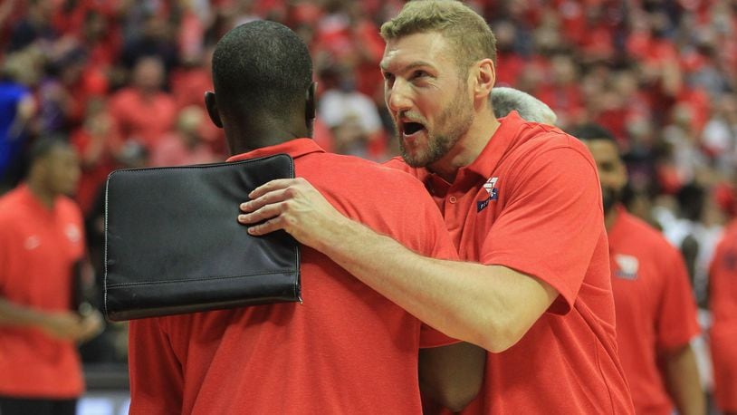 Dayton's Anthony Grant greets Sean Damaska as he leaves the court after a victory against Miami on Thursday, Nov. 25, 2021, in the first round of the ESPN Events Invitational at the HP Fieldhouse in Kissimmee, Fla. David Jablonski/Staff