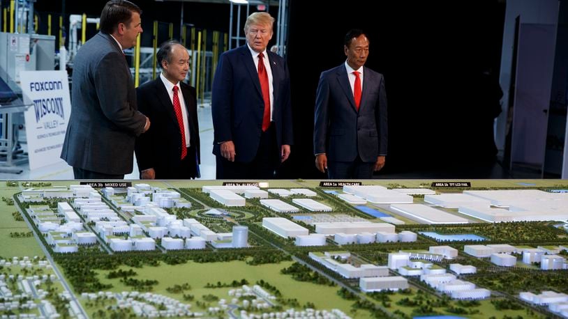 FILE - President Donald Trump tours a Foxconn facility, June 28, 2018, in Mt. Pleasant, Wis. (AP Photo/Evan Vucci, File)