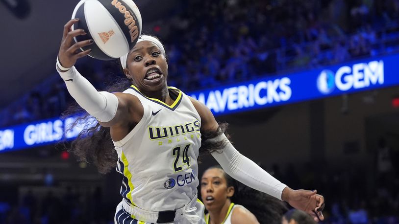 Dallas Wings guard Arike Ogunbowale (24) reaches for a rebound during the first half of the team's WNBA basketball basketball game against the Seattle Storm in Arlington, Texas, Thursday, June 13, 2024. (AP Photo/LM Otero)