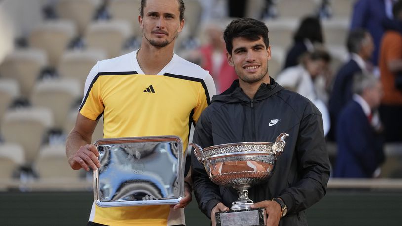 Winner Spain's Carlos Alcaraz, right, and second placed Germany's Alexander Zverev pose with their trophies after the men's final match of the French Open tennis tournament at the Roland Garros stadium in Paris, Sunday, June 9, 2024. (AP Photo/Thibault Camus)