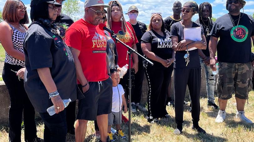 Dion Green, a community activist, speaks Sunday afternoon to a group grieving after the shooting of a youth Saturday by Dayton police. A rally was held on Negley Place, close to where the shooting happened. Participants said the person shot was 15 years old. THOMAS GNAU/STAFF
