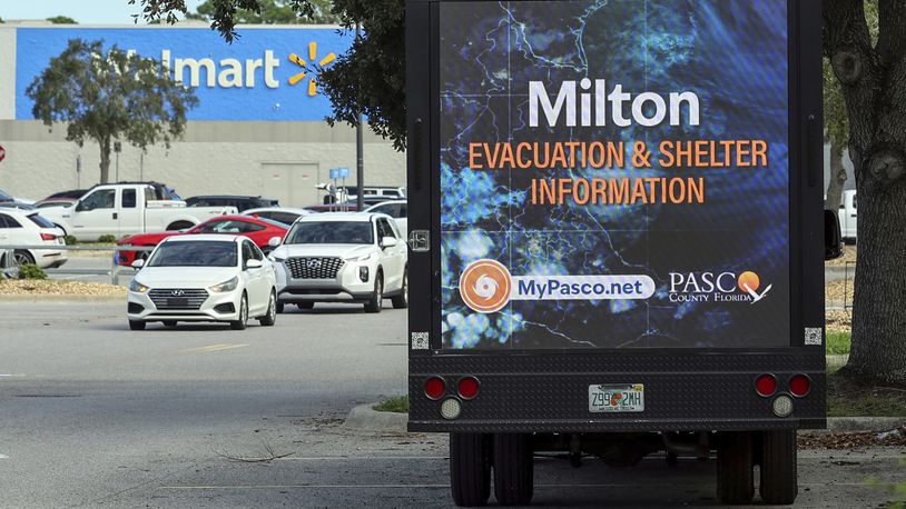 An LED signage truck with loudspeakers makes announcements informing residents of mandatory evacuations in preparation for Hurricane Milton on Tuesday, Oct. 8, 2024, in Port Richey, Fla. (AP Photo/Mike Carlson)