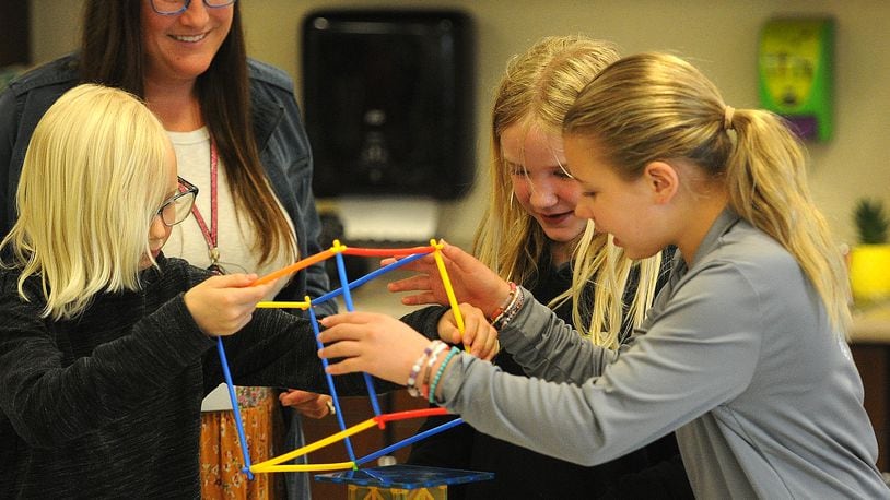 Miamisburg STEAM teacher Jessica Lay works with 4th grade students Wednesday, May 15, 2024 on a hands-on project, from left, Adelaide Tews, Emersyn Knox and Isabelle Cain. MARSHALL GORBY\STAFF