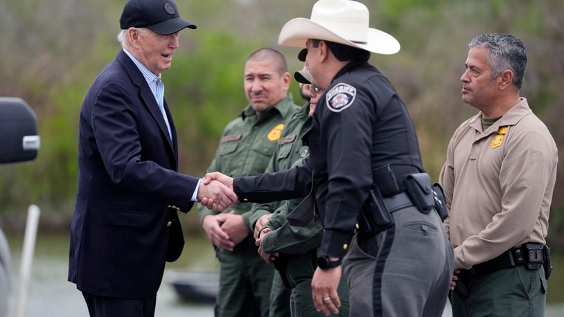 FILE - President Joe Biden talks with the U.S. Border Patrol and local officials, as he looks over the southern border, Feb. 29, 2024, in Brownsville, Texas, along the Rio Grande. Over the course of two weeks, President Joe Biden has imposed significant restrictions on immigrants seeking asylum in the U.S. and then offered potential citizenship to hundreds of thousands of people without legal status already living in the country. The two actions in tandem gives the president a chance to address one of the biggest vulnerabilities for his reelection campaign. (AP Photo/Evan Vucci, File)