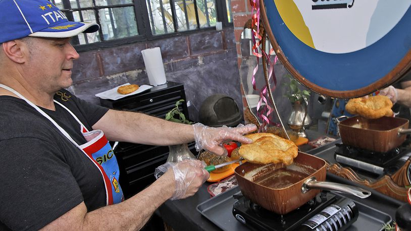 Tom Thompson, owner of Eatly, deep fries a pizza dough Thursday, May 23, 2024. BILL LACKEY/STAFF