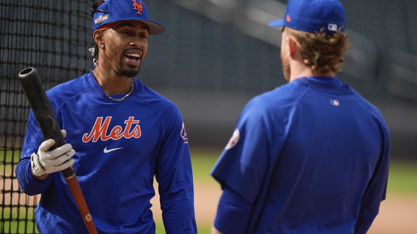 New York Mets shortstop Francisco Lindor talks to outfielder Harrison Bader during batting practice before playing against the Philadelphia Phillies in Game 3 of the National League baseball playoff series, Tuesday, Oct. 8, 2024, in New York. (AP Photo/Frank Franklin II)