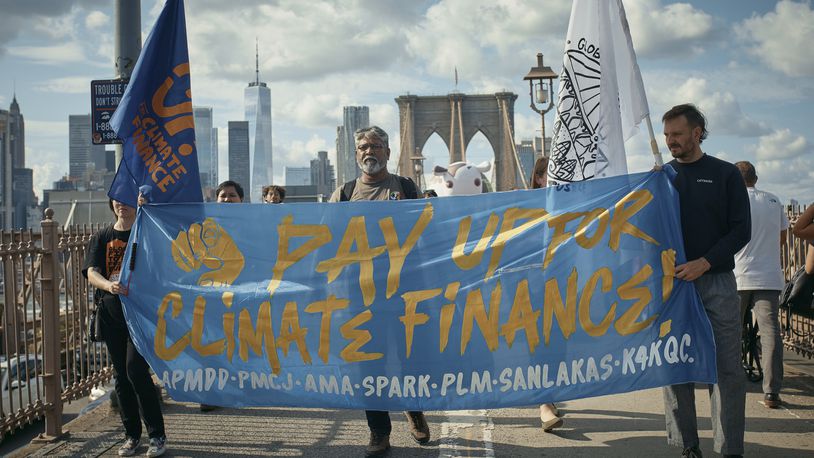 Protesters cross the Brooklyn Bridge during a Youth Climate Strike march to demand an end to the era of fossil fuels, Friday, Sept. 20, 2024, in New York. (AP Photo/Andres Kudacki)