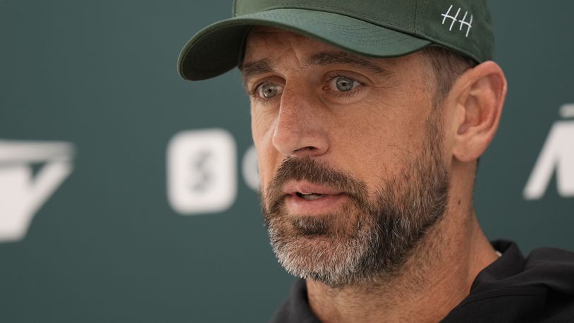 New York Jets quarterback Aaron Rodgers (8) speaks during a press conference in Ware, England, Friday, Oct. 4, 2024, ahead of the game between New York Jets and Minnesota Vikings at the Tottenham Hotspur stadium on Sunday. (AP Photo/Alastair Grant)