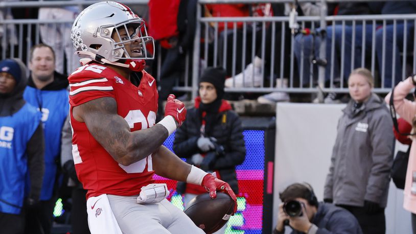 Ohio State running back TreVeyon Henderson celebrates after his touchdown against Minnesota during the first half of an NCAA college football game Saturday, Nov. 18, 2023, in Columbus, Ohio. (AP Photo/Jay LaPrete)