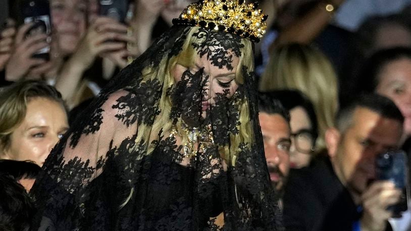 Madonna stands at the end of the Dolce & Gabbana Spring Summer 2025 fashion show, that was presented in Milan, Italy, Saturday, Sept. 21, 2024. (AP Photo/Antonio Calanni)