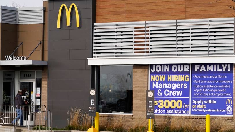 A hiring sign is displayed outside of McDonald's in Buffalo Grove, Ill., Thursday, Nov. 19, 2020. The number of applications for unemployment benefits rose sharply last week, indicating continued challenges for the U.S. economic recovery as coronavirus infections increased around the country. (AP Photo/Nam Y. Huh)