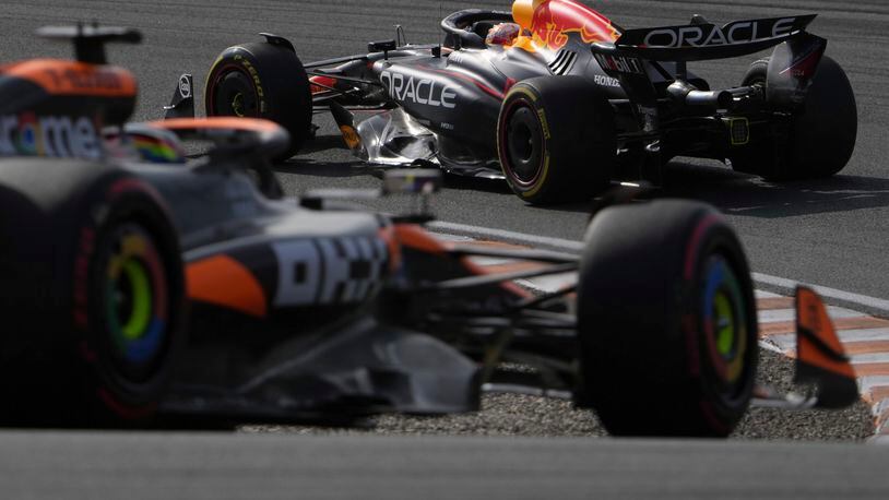 Red Bull driver Max Verstappen of the Netherlands, right, steers his car during the second practice session ahead of the Formula One Dutch Grand Prix auto race, at the Zandvoort racetrack, Netherlands, Friday, Aug. 23, 2024. (AP Photo/Peter Dejong)