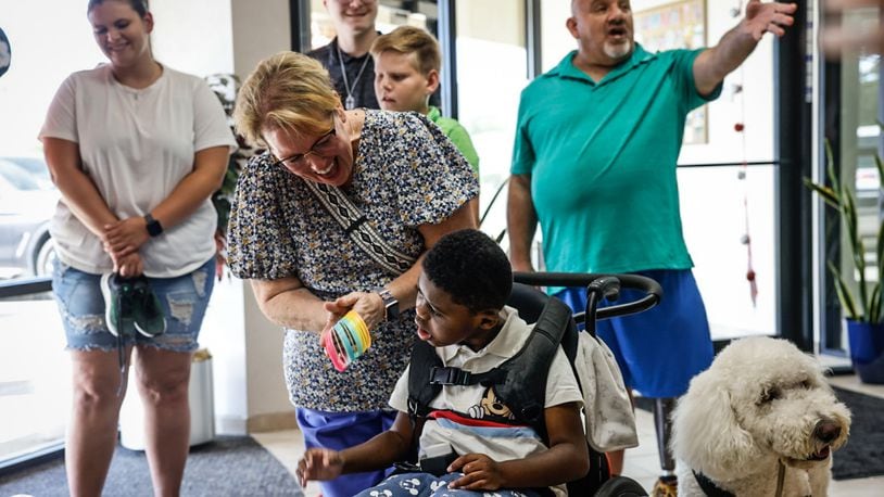 The Fisher family of Moraine received the 1,900th wish from A Special Wish Foundation of Southwest Ohio at River Valley Credit Union in West Carrollton on Wednesday, Sept. 4, 2024. The family plans to visit Disney World in Florida. JIM NOELKER/STAFF