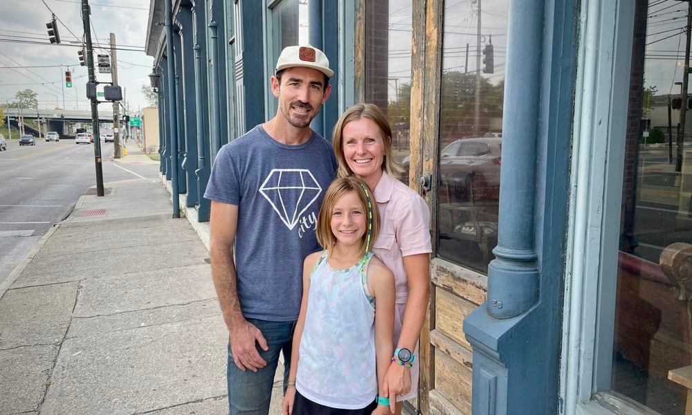 Burgess and Jeanine Gow of 521 LLC have purchased the Dietz Block building on Wayne Avenue in Dayton. Pictured with the couple is their daughter, Kay. NATALIE JONES/STAFF