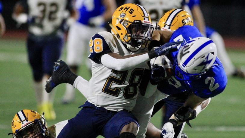 Springfield's Jaivian Norman makes a tackle against St. Xavier in a Division I state semifinal on Friday, Nov. 6, 2020, at Alexander Stadium in Piqua. David Jablonski/Staff