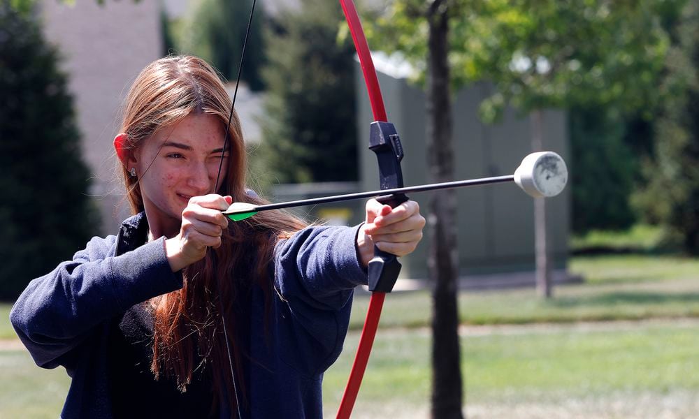 First year Sinclair Community College student, Alisa Romenskaya participated in archery Thursday, Aug. 29, 2024 at the Tartan Lawn Party as part of Sinclair Community College welcome week celebration. MARSHALL GORBY\STAFF