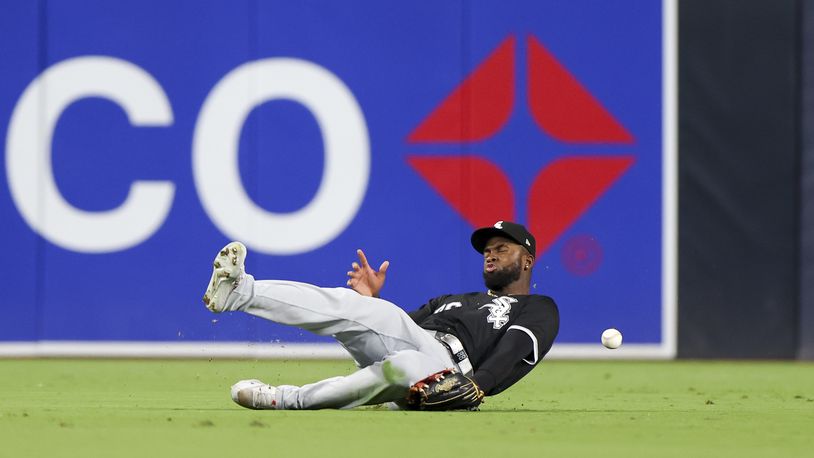 Chicago White Sox center fielder Luis Robert Jr. is unable to handle a double hit by San Diego Padres' Jurickson Profar during the fifth inning of a baseball game, Saturday, Sept. 21, 2024, in San Diego. (AP Photo/Ryan Sun)