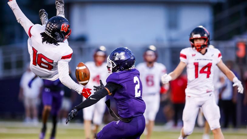 Lakota West's Kolyn Ogletree (16) and Middletown's Maximillian Johnson (2) battle for a pass during their game. Lakota West defeated Middletown 51-7 in their football game Friday, Sept. 20, 2024 at Barnitz Stadium in Middletown. NICK GRAHAM/STAFF