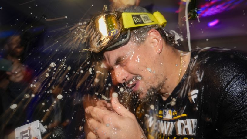 Milwaukee Brewers' Willy Adames is douced after a baseball game against the Philadelphia Phillies Wednesday, Sept. 18, 2024, in Milwaukee. The Brewers won 2-1 and clinched the National League Central division. (AP Photo/Morry Gash)