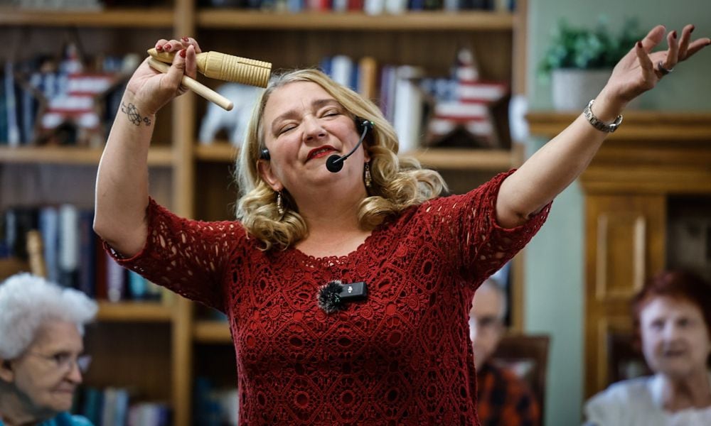 Community Gem Krissy O'Malley sings and dances with the residence of Brookdale Centennial Park Senior Living. O'Malley is the owner and founder of Senior Music Connection. JIM NOELKER/STAFF