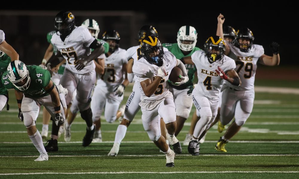 Centerville's Braylon Newcomb runs for a touchdown in the fourth quarter against Dublin Coffman on Friday, Aug. 25, 2023, at Coffman Stadium in Dublin. David Jablonski/Staff