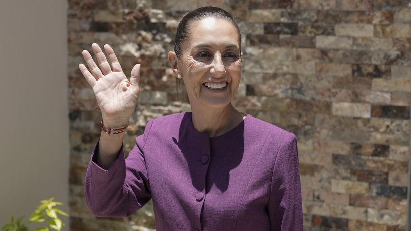 Mexico's future President Claudia Sheinbaum waves before the start of her press conference at her campaign headquarters, in Mexico City, Tuesday, June 11, 2024. (AP Photo/Eduardo Verdugo)
