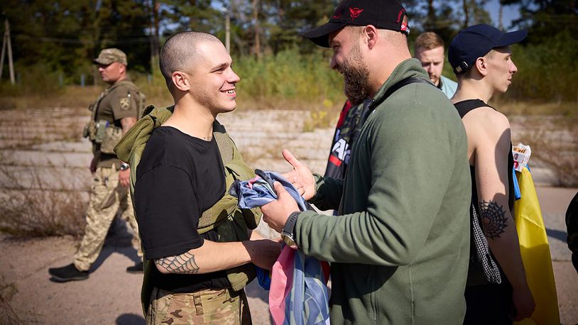 A Ukrainian serviceman, left, is greeted after being released in a prisoner exchange at an undisclosed location in Ukraine, Saturday Sept. 14, 2024. (Ukrainian Presidential Press Office via AP)