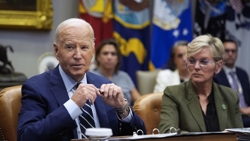 President Joe Biden delivers remarks on the federal government's response to Hurricane Helene and preparations for Hurricane Milton in the Roosevelt Room of the White House, Tuesday, Oct. 8, 2024, in Washington, as Secretary of Energy Jennifer Granholm looks on. (AP Photo/Evan Vucci)