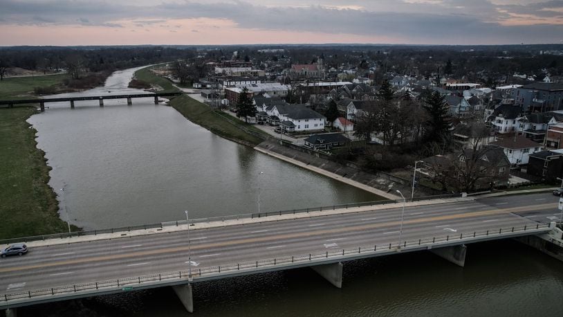 An aerial view of Troy, looking from the Market Street bridge area over the Great Miami River, toward Water Street and the surrounding neighborhood to the east. The Spinnaker site is on the right (south) riverbank, in the distance where the river narrows. JIM NOELKER/STAFF