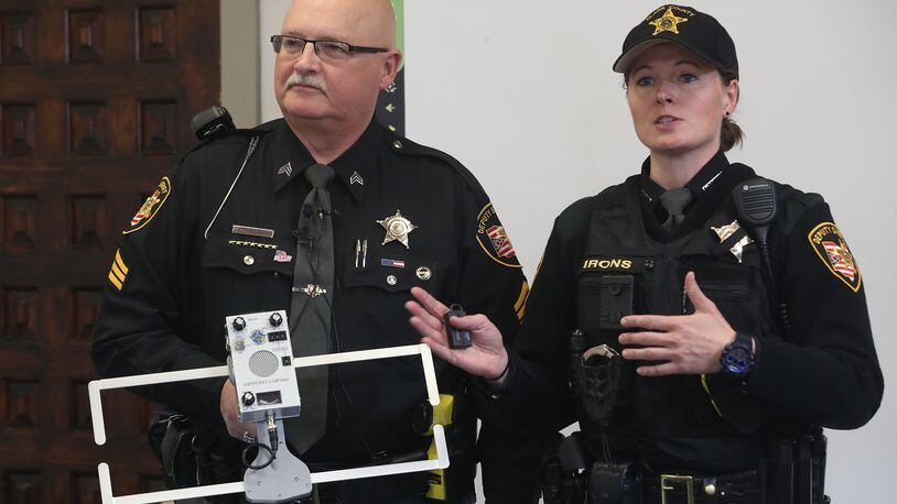 Clark County Sheriff's Sgt. Ralph Underwood and Deputy Jolene Irons talk about the the new Project Lifesaver that the Sheriff's office is being trained on this week to track individuals with cognitive problems, such as alzheimer's disease, if they get lost. BILL LACKEY/STAFF