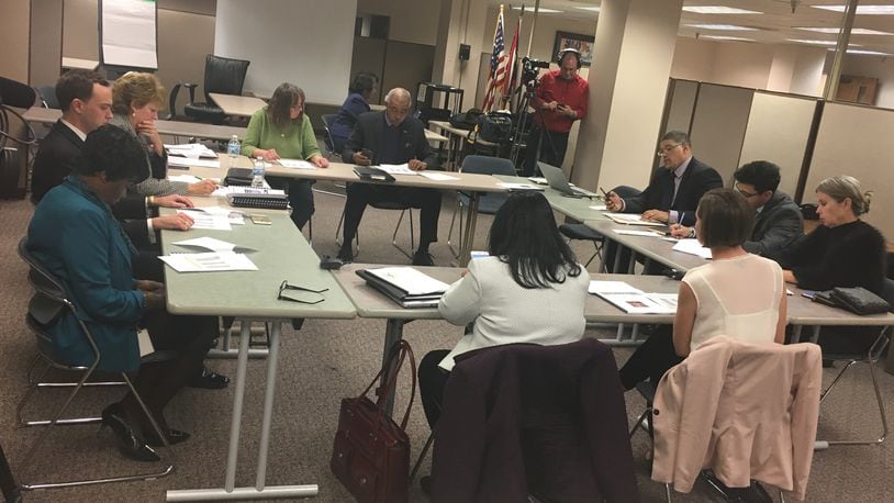 Current and incoming Dayton school board members discuss leadership roles for 2018 on Tuesday, Dec. 19. JEREMY P. KELLEY / STAFF