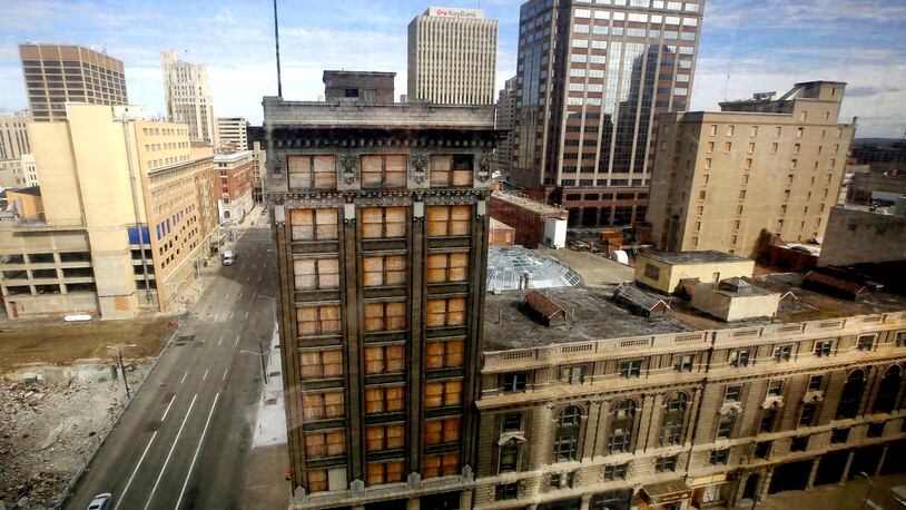 Exterior view of the Arcade from the 40 W. Fourth Building. The arcade can be redeveloped, a Dayton consultant is saying. “We believe that a major redevelopment of the arcade block is feasible and warranted, ” a report by Sandvick Architects says in a section titled “summary and recommendations.” “There is a need for market rate and affordable downtown residential units that can offer safe, secured parking with amenities that highlight the urban living experience, ” the report adds. “The arcade block is a spectacular architectural gem of not only statewide but national significance. Its exceptional quality of space and design excellence have the capacity to dramatically increase the success of the proposed uses.” In December 2014, the city of Dayton commissioned Sandvick and THP Limited Inc. in Cincinnati to analyze the possibility of arcade redevelopment into a downtown living space. The historical arcade — for decades a much-loved centerpiece of downtown Dayton — consists of nine interconnected and surrounding buildings. The analysis was to offer a task force selected by Mayor Nan Whaley with data and cost estimates of proposed uses and demolition scenarios.. TY GREENLEES / STAFF